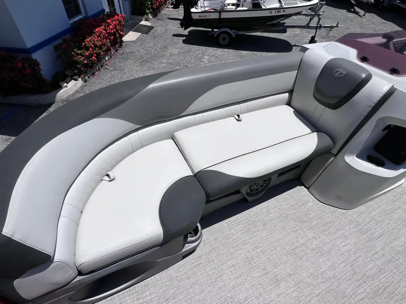 Slide: The Image of 2022 Tahoe Pontoon LTZ 2485 EL interior with gray seating and cup holder. - 24