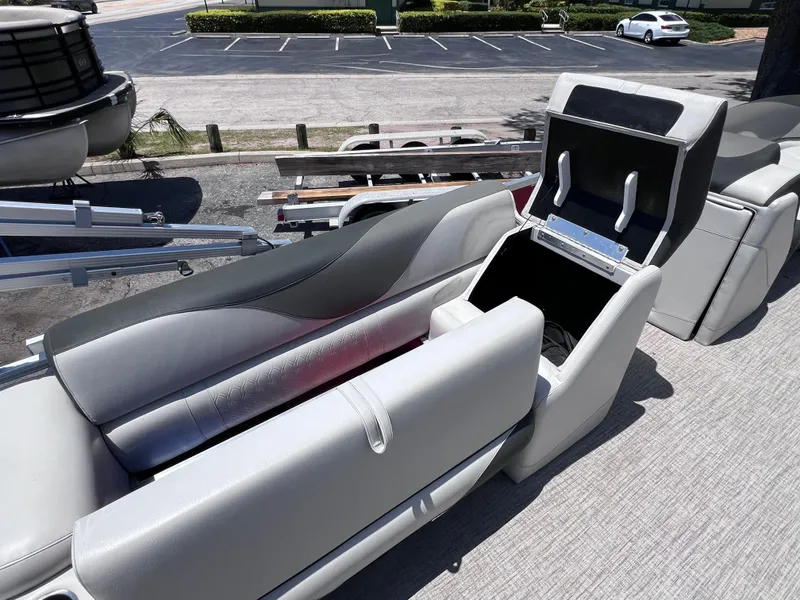 Slide: The Image of 2022 Tahoe Pontoon LTZ 2485 EL boat seating with open storage compartment. - 26