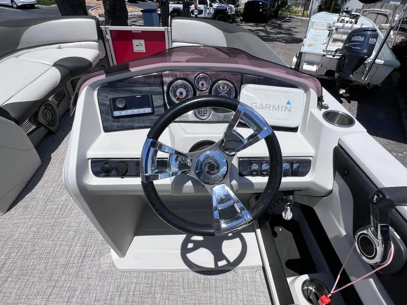 Slide: The Image of 2022 Tahoe Pontoon LTZ 2485 EL dashboard with steering wheel and Garmin navigation system. - 29