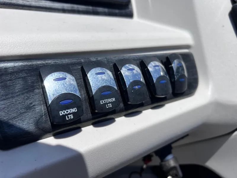 Slide: The Image of Control panel switches on a 2022 Tahoe Pontoon LTZ 2485 EL boat. - 32