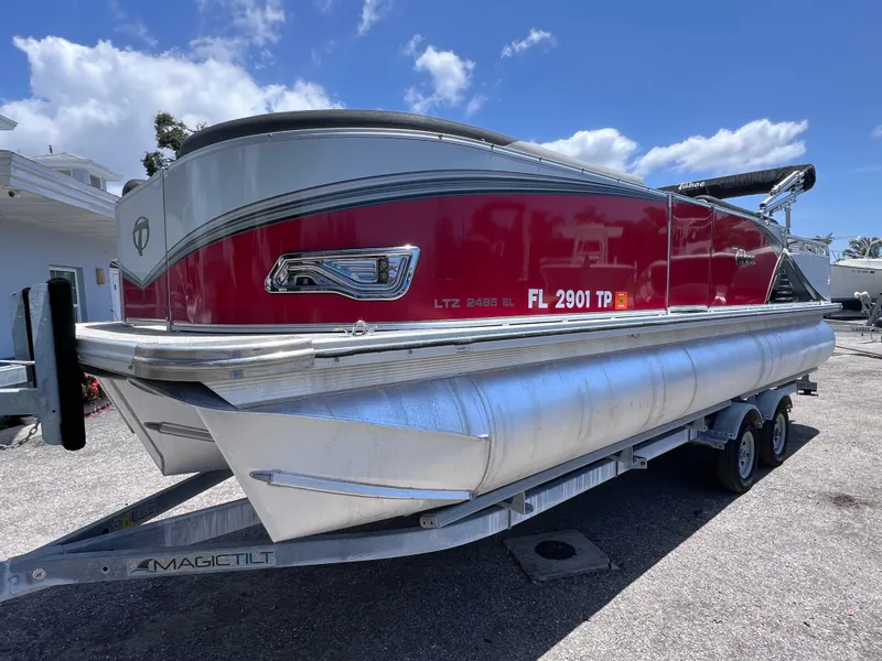 Slide: The Image of 2022 Tahoe Pontoon LTZ 2485 EL on trailer, red and silver design, sunny day. - 6
