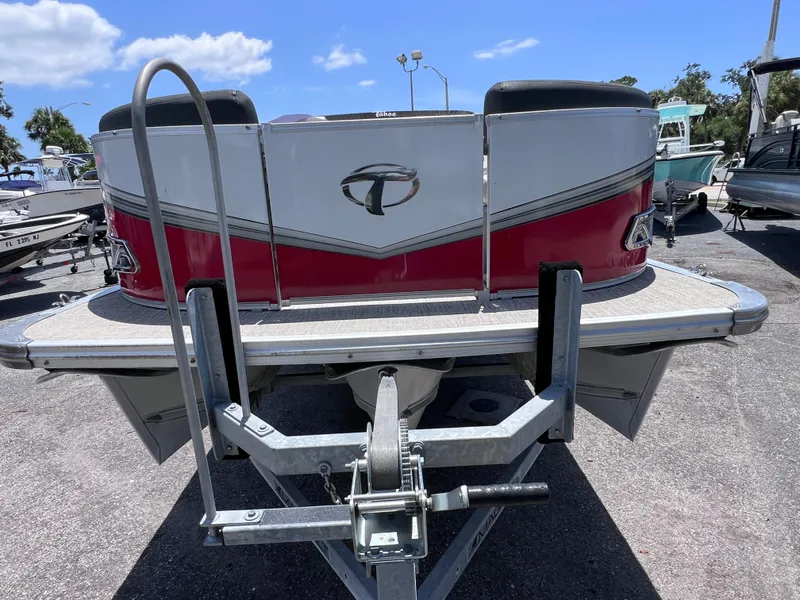 Slide: The Image of 2022 Tahoe Pontoon LTZ 2485 EL on trailer, red and silver design, sunny day. - 7