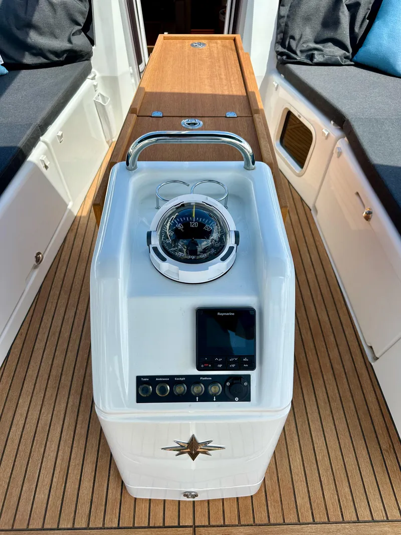 Slide: The Image of 2024 Jeanneau Sun Odyssey 410 cockpit with compass and navigation controls. - 19