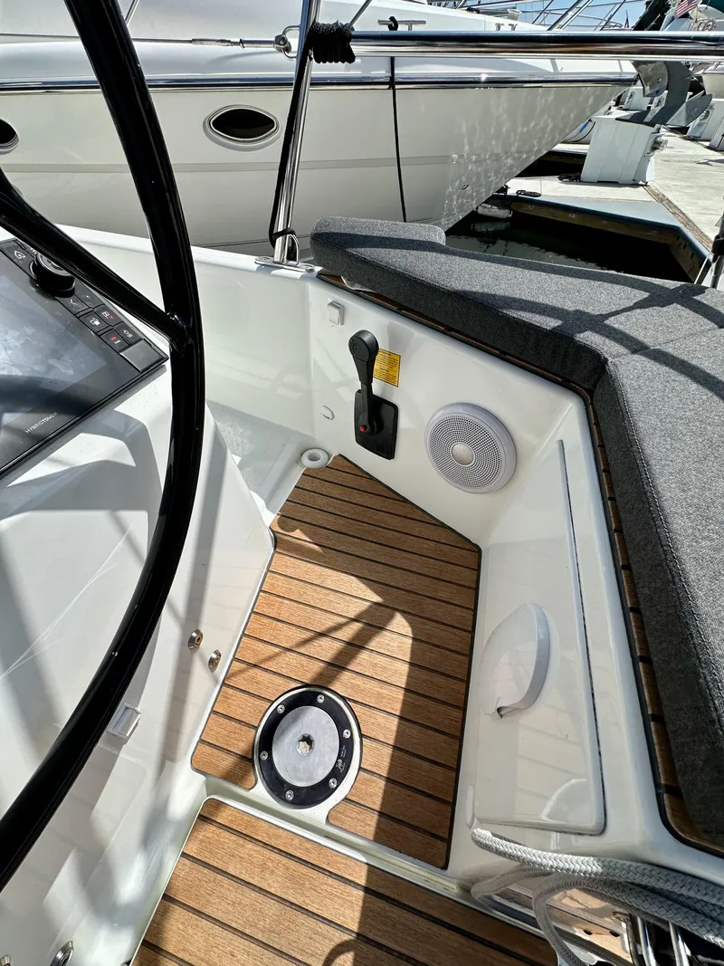 Slide: The Image of Cockpit of 2024 Jeanneau Sun Odyssey 410 with teak flooring and control panel. - 23
