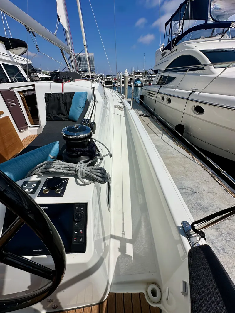 Slide: The Image of 2024 Jeanneau Sun Odyssey 410 sailboat docked, showcasing deck and control panel. - 26