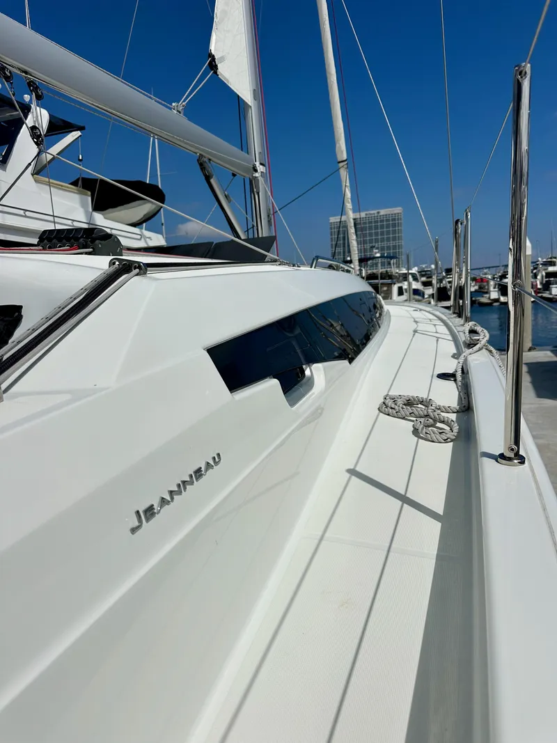 Slide: The Image of 2024 Jeanneau Sun Odyssey 410 sailboat docked, showcasing sleek design and modern features. - 28