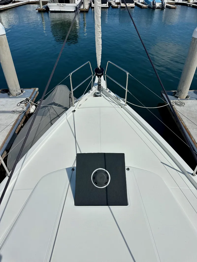 Slide: The Image of 2024 Jeanneau Sun Odyssey 410 yacht bow at marina, showcasing sleek design and mooring setup. - 30
