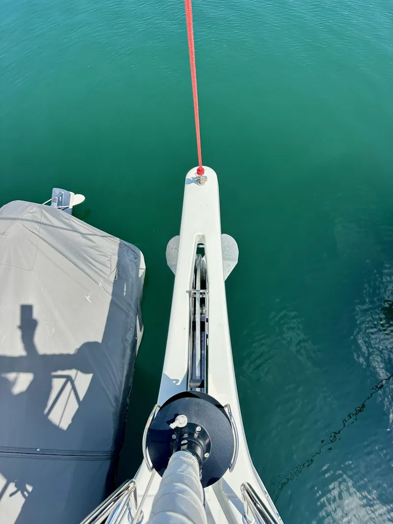 Slide: The Image of Bow view of 2024 Jeanneau Sun Odyssey 410 sailboat on calm water. - 34