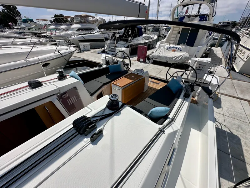 Slide: The Image of 2024 Jeanneau Sun Odyssey 410 sailboat docked, featuring spacious cockpit and modern design. - 38