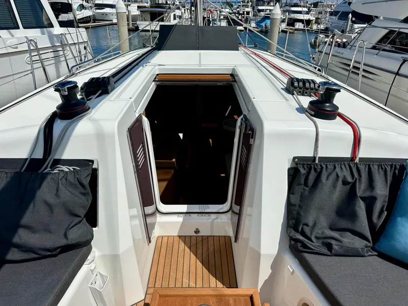 Slide: The Image of 2024 Jeanneau Sun Odyssey 410 yacht cockpit with open cabin door, docked at marina. - 43