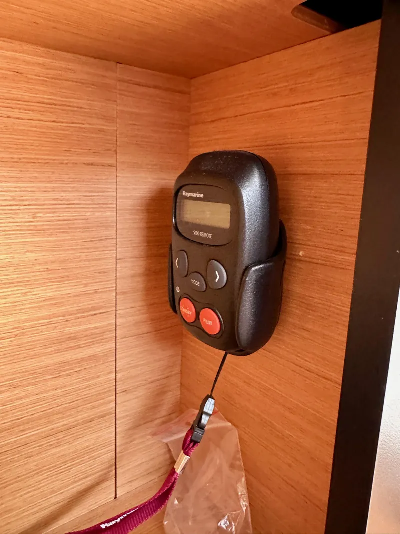 Slide: The Image of Raymarine remote control mounted on Jeanneau Sun Odyssey 410, 2024 model, wooden interior. - 49