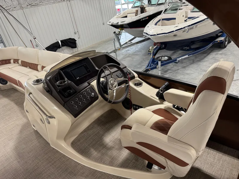 Slide: The Image of 2022 Bennington QX 30 boat interior with luxurious seating and modern dashboard controls. - 11