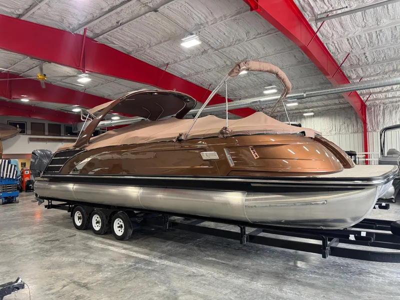 Slide: The Image of 2022 Bennington QX 30 pontoon boat in a warehouse, on a trailer. - 12