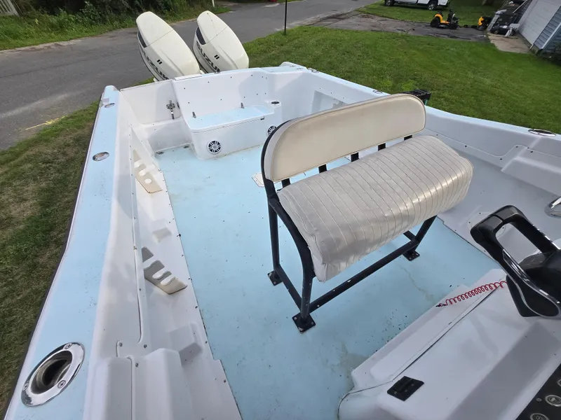 Slide: The Image of 1994 Grady-White Chase 263 boat interior with seating and dual outboard motors. - 10