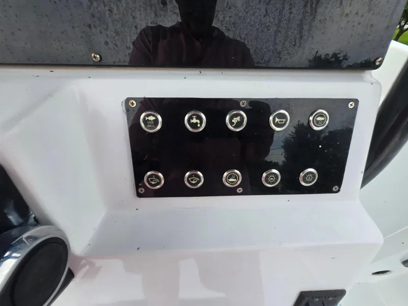 Slide: The Image of Control panel of a 1994 Grady-White Chase 263 boat with various switches. - 15