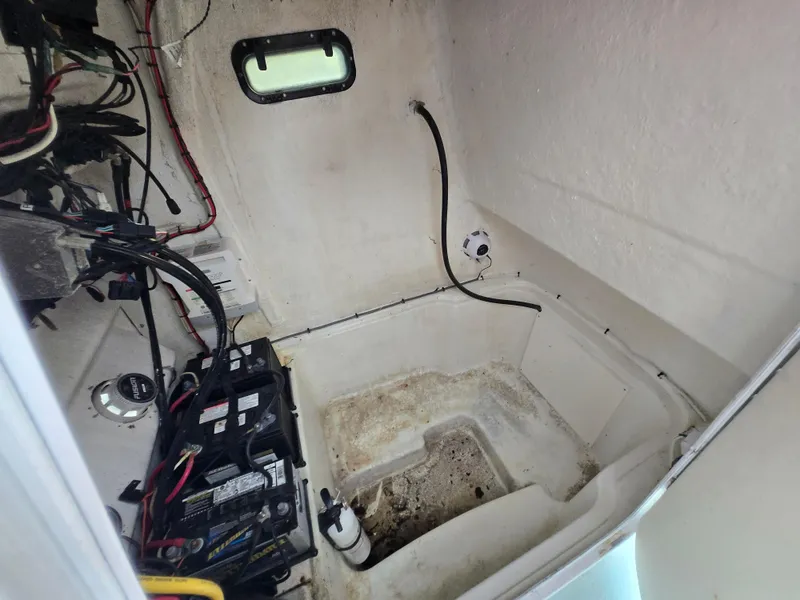 Slide: The Image of 1994 Grady-White Chase 263 boat interior with wiring and battery setup. - 18
