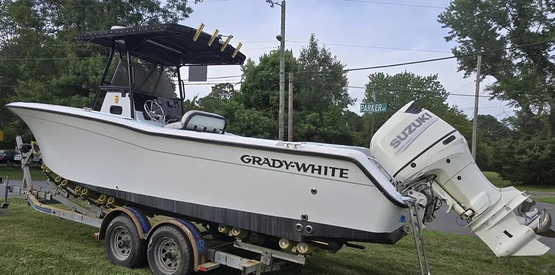 Slide: The Image of 1994 Grady-White Chase 263 boat on trailer with Suzuki outboard motor. - 2