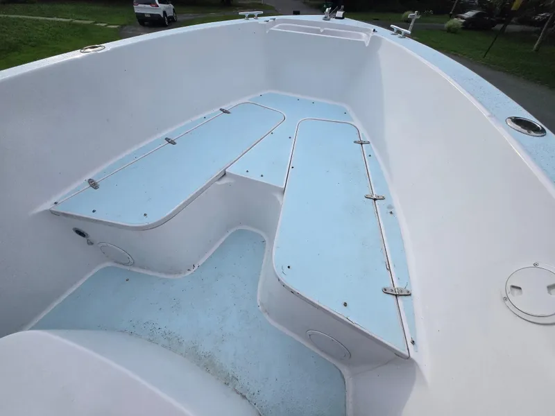 Slide: The Image of 1994 Grady-White Chase 263 boat interior with storage compartments and seating. - 8