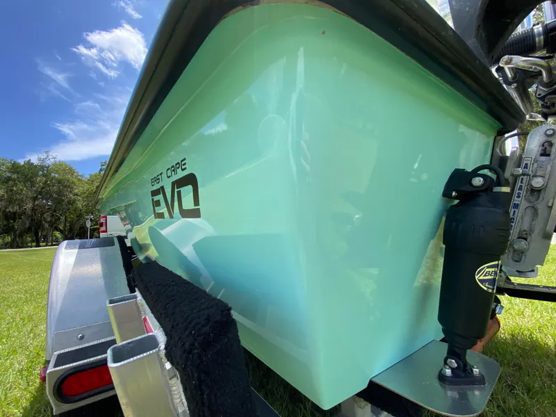 Slide: The Image of 2020 East Cape 18 EVO boat on trailer, bright blue hull, sunny day. - 13