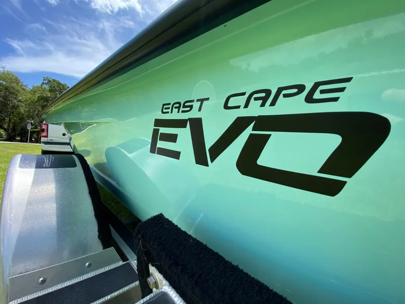 Slide: The Image of 2020 East Cape 18 EVO boat on trailer, close-up view under blue sky. - 14