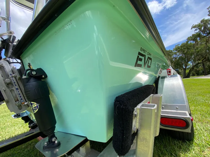 Slide: The Image of 2020 East Cape 18 EVO boat on trailer, green hull, sunny day. - 17