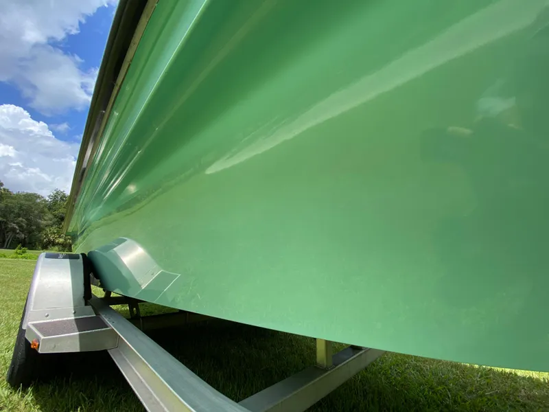 Slide: The Image of Green 2020 East Cape 18 EVO boat on trailer under blue sky. - 19
