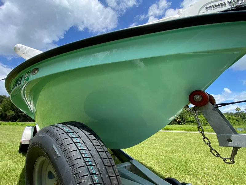 Slide: The Image of 2020 East Cape 18 EVO boat on trailer, under blue sky. - 20