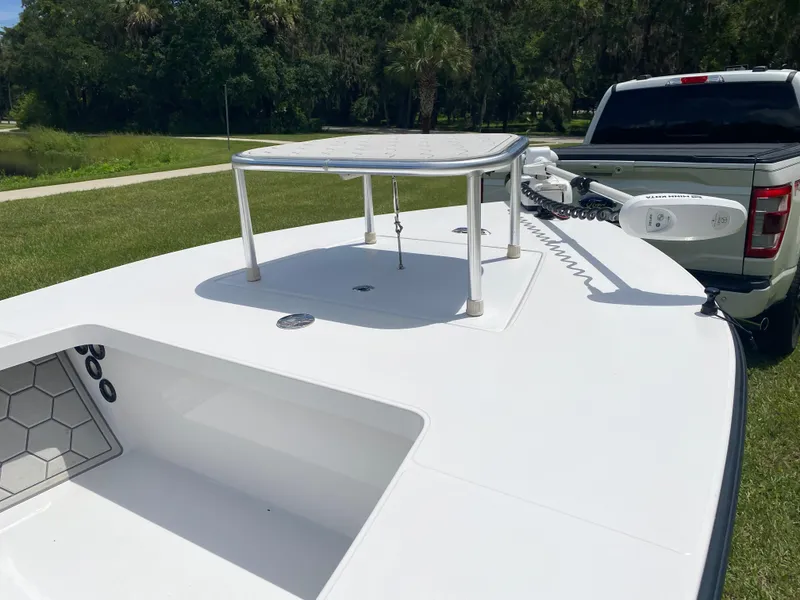 Slide: The Image of 2020 East Cape 18 EVO boat on trailer, featuring a sleek white deck and modern design. - 22