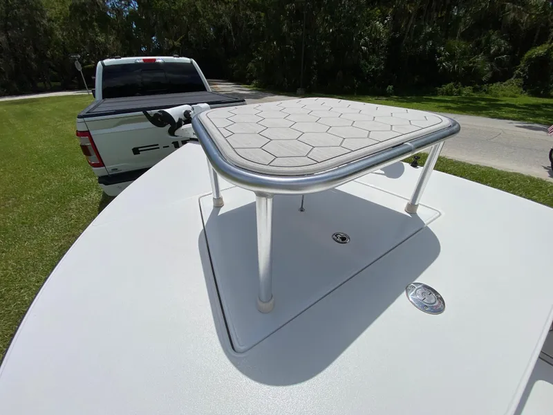 Slide: The Image of 2020 East Cape 18 EVO boat with elevated platform, parked near a Ford F-150 truck. - 24