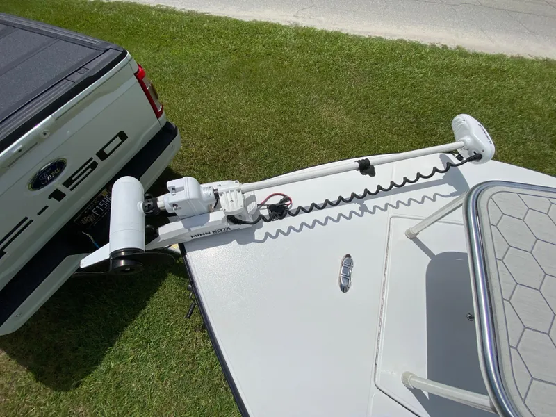 Slide: The Image of 2020 East Cape 18 EVO boat with Minn Kota trolling motor, parked beside a Ford F-150. - 25