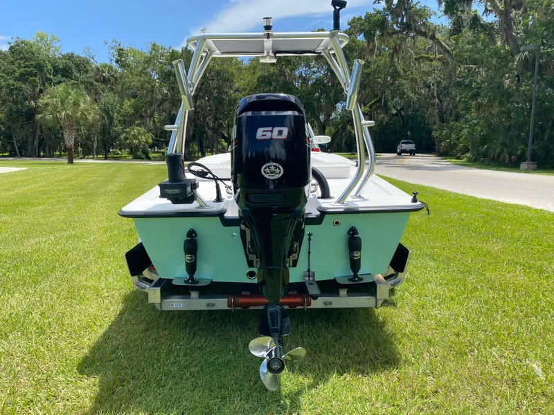 Slide: The Image of 2020 East Cape 18 EVO boat with 60 HP engine on grassy area. - 3