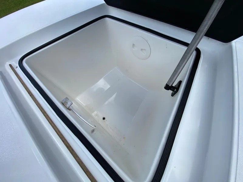 Slide: The Image of Open storage compartment of 2020 East Cape 18 EVO boat, featuring a clean interior. - 30