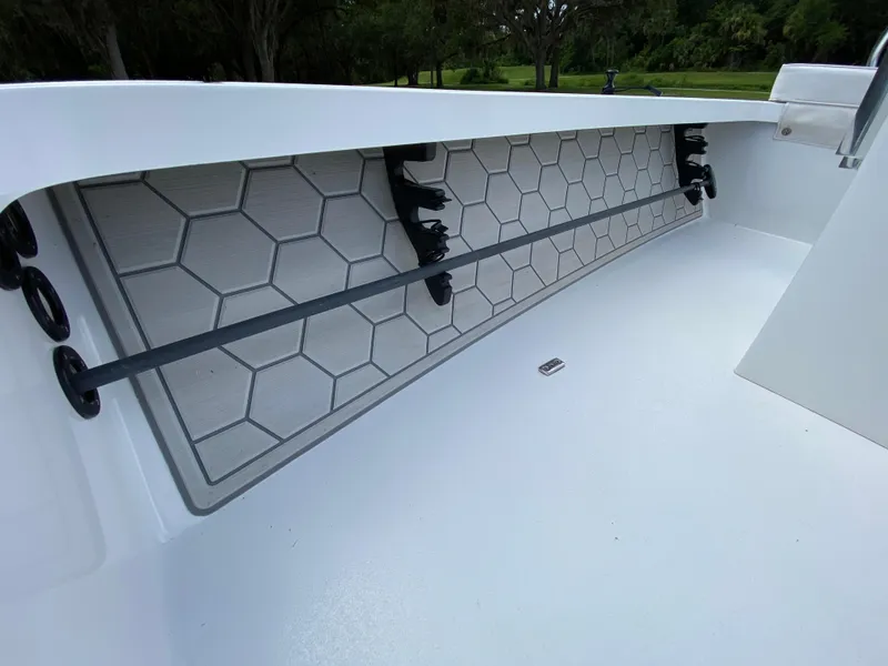 Slide: The Image of 2020 East Cape 18 EVO boat interior with hexagonal pattern and rod holders. - 32
