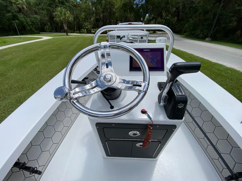 Slide: The Image of 2020 East Cape 18 EVO boat console with steering wheel and navigation system. - 38