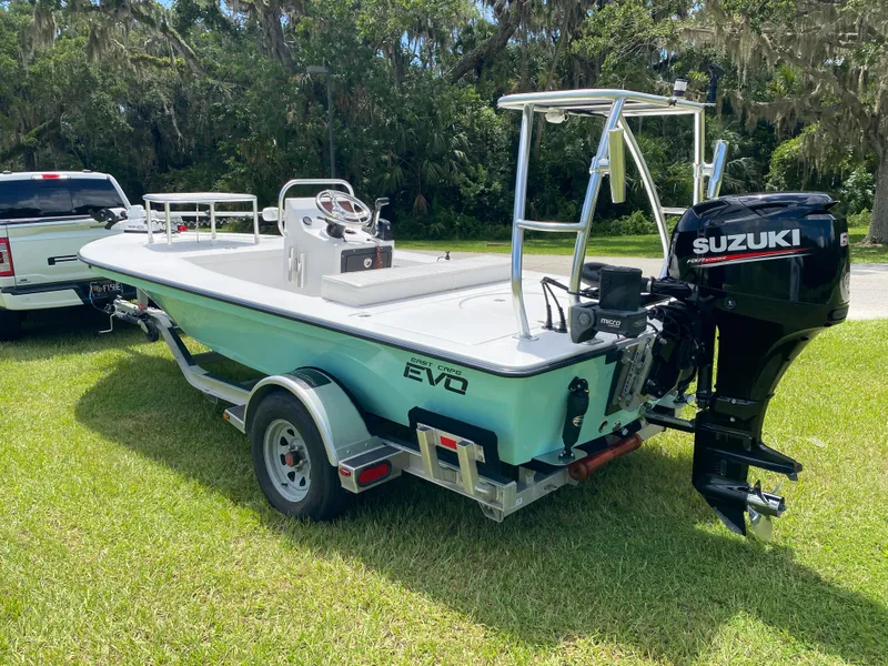 Slide: The Image of 2020 East Cape 18 EVO boat with Suzuki engine on trailer, parked on grass. - 4