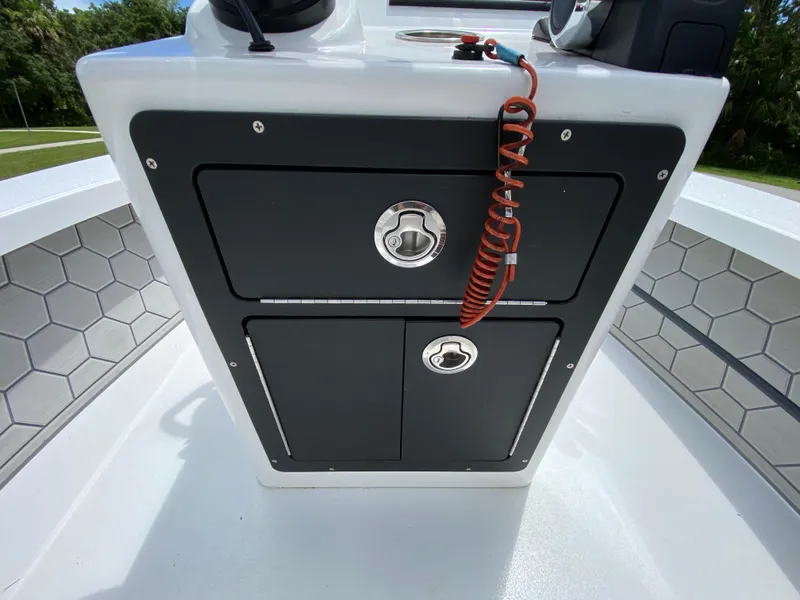 Slide: The Image of 2020 East Cape 18 EVO boat console with storage compartments and safety cord. - 41