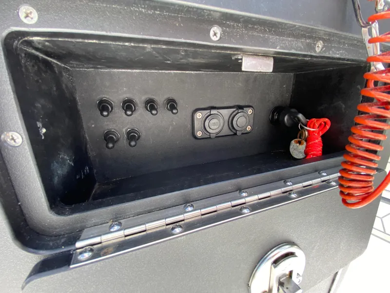 Slide: The Image of Control panel of 2020 East Cape 18 EVO boat with switches and USB ports. - 42