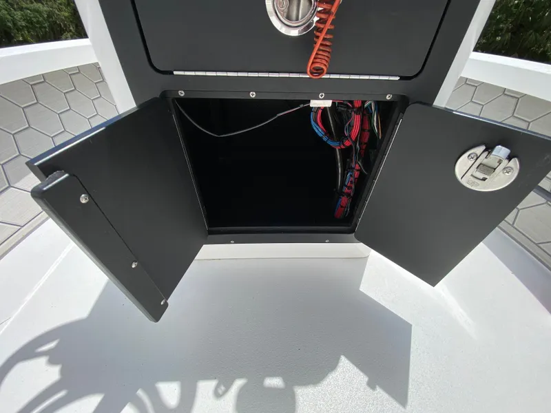 Slide: The Image of Open storage compartment on 2020 East Cape 18 EVO boat, showing wiring and interior details. - 43