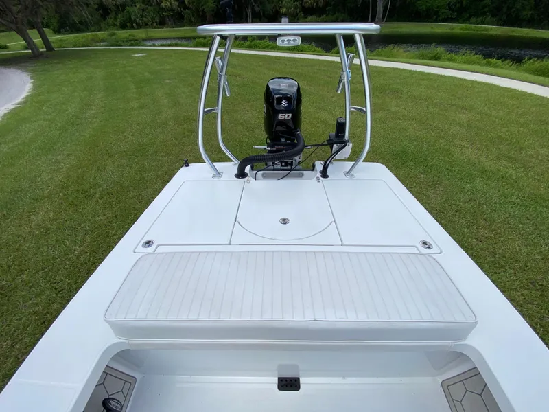 Slide: The Image of 2020 East Cape 18 EVO boat with Suzuki 60 engine on grassy landscape. - 45