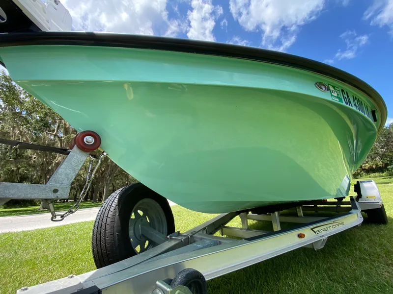 Slide: The Image of 2020 East Cape 18 EVO boat on trailer, green hull, sunny day. - 8