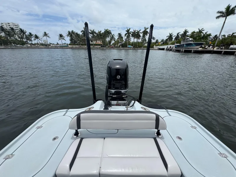 Slide: The Image of 2019 Yellowfin 24 Bay CE boat on calm water with palm trees in background. - 17