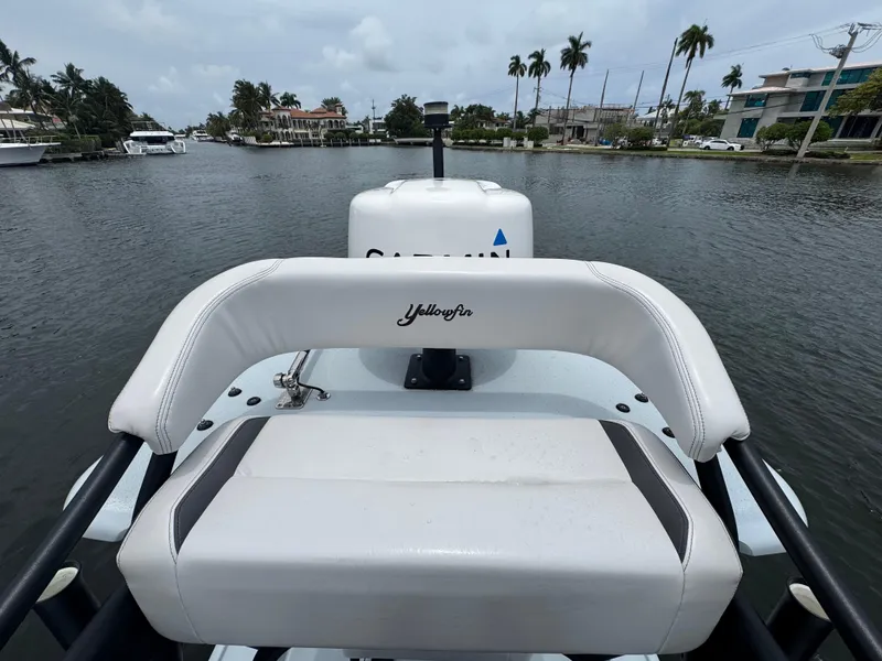 Slide: The Image of 2019 Yellowfin 24 Bay CE boat on a calm waterway, surrounded by palm trees. - 29