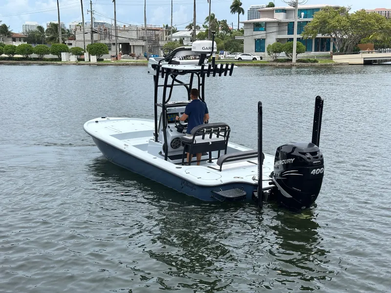 Slide: The Image of 2019 Yellowfin 24 Bay CE boat on water, featuring Mercury 400 engine. - 3