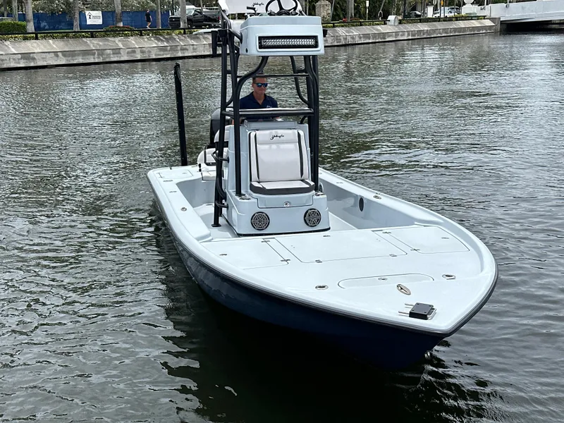 Slide: The Image of 2019 Yellowfin 24 Bay CE boat on calm water, front view. - 8