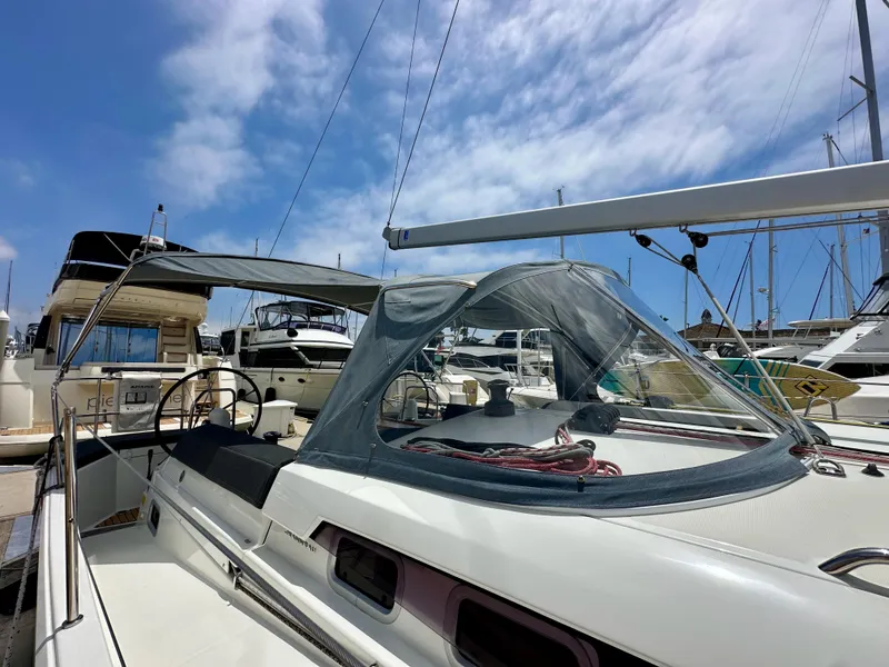 Slide: The Image of 2021 Jeanneau Sun Odyssey 440 sailboat docked at marina under blue sky. - 10