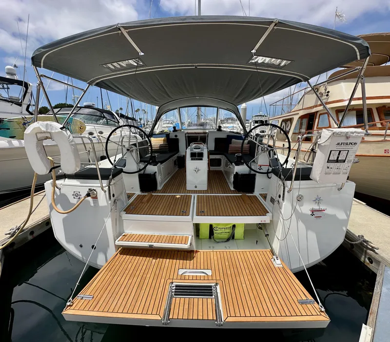 Slide: The Image of 2021 Jeanneau Sun Odyssey 440 sailboat with spacious deck and dual steering wheels. - 14