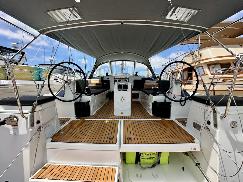 Slide: The Image of 2021 Jeanneau Sun Odyssey 440 yacht cockpit with dual steering wheels and teak flooring. - 16