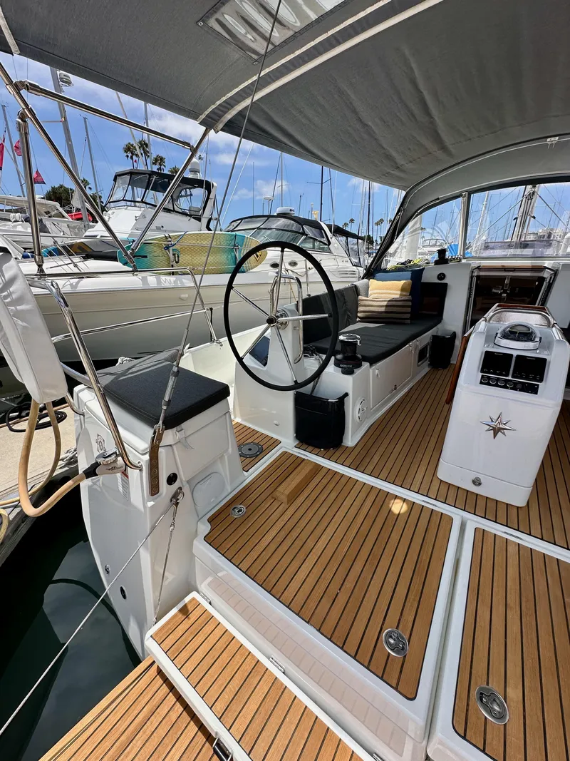 Slide: The Image of 2021 Jeanneau Sun Odyssey 440 yacht cockpit with teak flooring and steering wheel. - 17