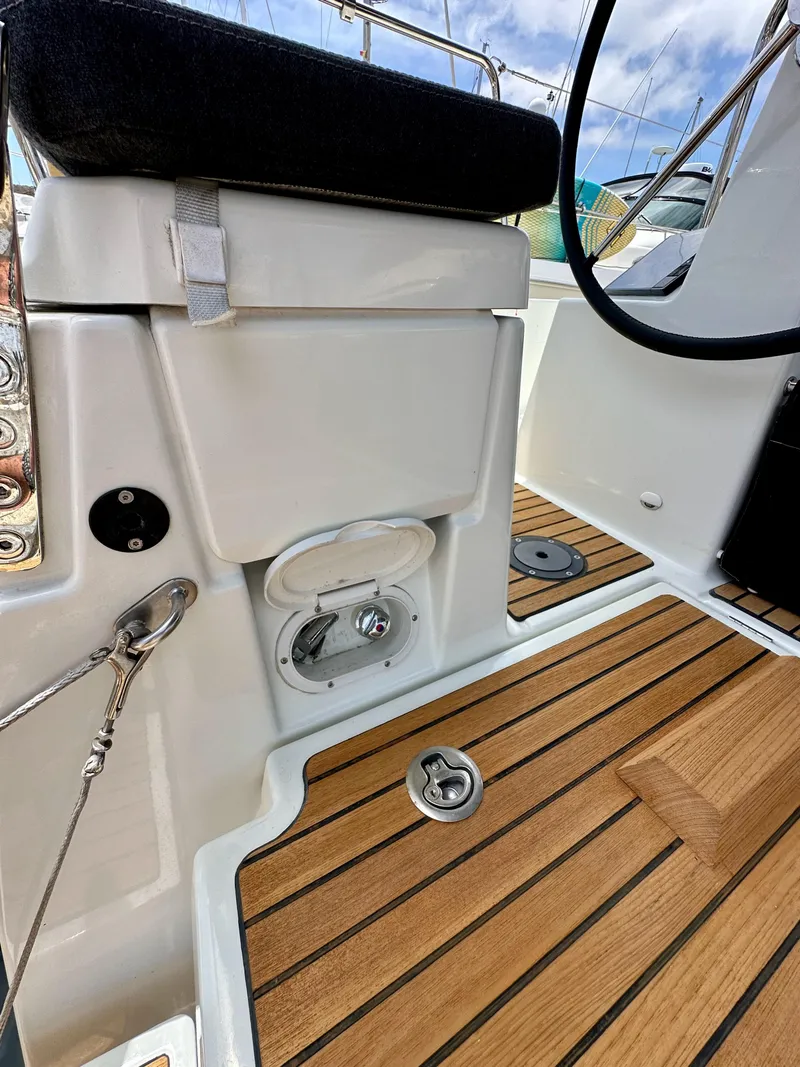 Slide: The Image of Cockpit area of 2021 Jeanneau Sun Odyssey 440 with teak flooring and seating. - 19