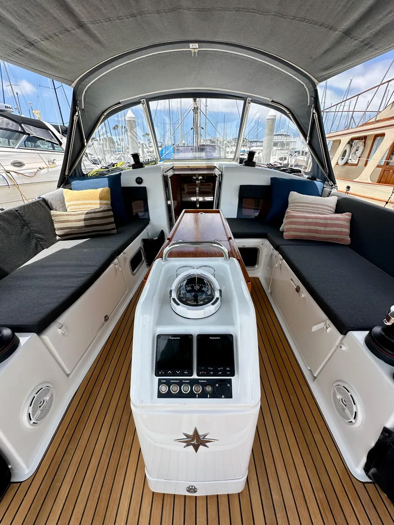 Slide: The Image of Interior of 2021 Jeanneau Sun Odyssey 440 sailboat with cushioned seating and navigation equipment. - 22